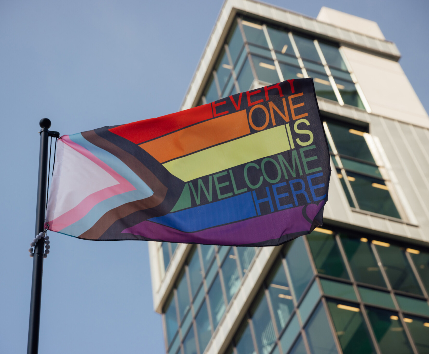 A rainbow pride flag with the words "Every one is welcome here" adorning it flies in front of the Cencora office in Conshohocken, PA.
